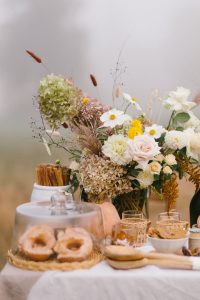 Doughnuts and floral bouquet in a field
