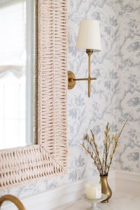 Wicker Mirror with Gold Sconce and Toile De Fleurs Wallpaper Close Up
