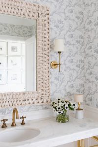 Wicker Mirror with Gold Sconce and Toile De Fleurs Wallpaper