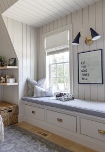 Window seat styled with pillows and chess set